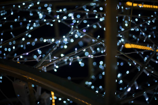 istock Texture made of LEDs. Garlands in dark. Bright light bulbs on black background. 2162898877