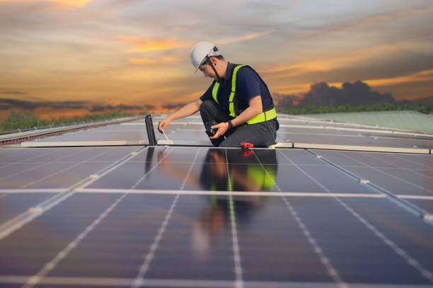 istock Male engineer inspecting solar panels on the roof Engineer or worker working on solar panels or photovoltaic cells on the roof of a business building. 2162899744