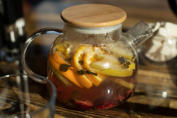 istock Teapot with tea on table. Summer fruit drink. Fruit tea in clear teapot. 2162901000