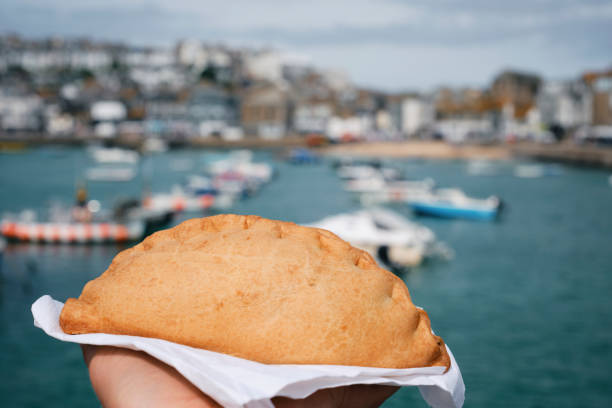 istock Hand holding a Cornish Pasty at the Harbour in St. Ives, Cornwall. 2162901006