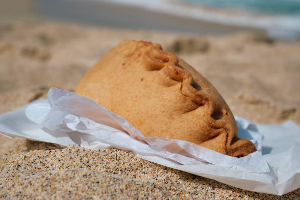 Cornish Pasty on the beach at St. Ives, Cornwall on a sunny June day.