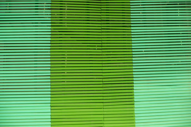 Large green blinds. Texture of blinds.Protection from light. Bright green tone.
