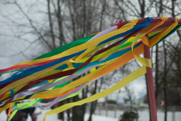 Folk Spring Festival. Colored ribbons on hoop. Totem object. Pagan rite. Ribbons in wind.