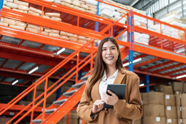 istock Smiling Female Manager in Warehouse with Tablet. 2162902156