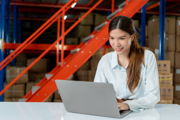 istock Smiling Female Warehouse Worker on Laptop. 2162902212
