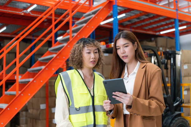istock Warehouse Supervisor and Manager Reviewing Tablet. 2162902240