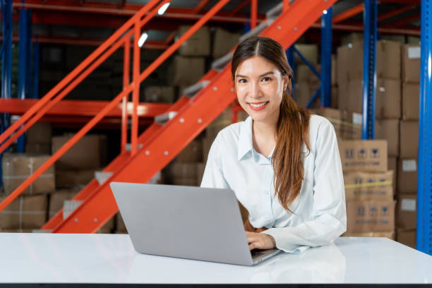 istock Smiling Female Warehouse Worker on Laptop. 2162902275