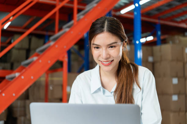 istock Smiling Female Warehouse Worker on Laptop. 2162902287