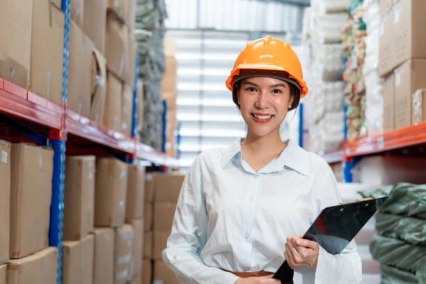istock Smiling female warehouse worker in hard hat. 2162902366