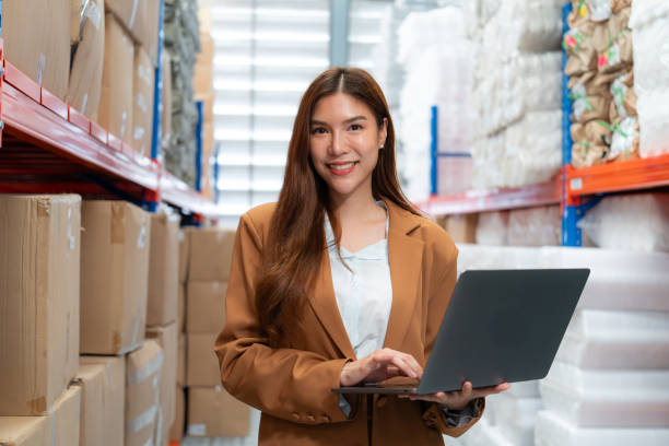 istock Businesswoman Using Laptop in Warehouse. 2162902374