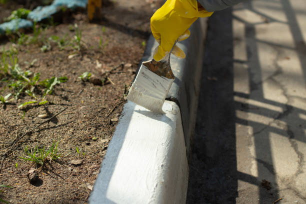 istock Road edge marking. Brush with white paint. 2162904399