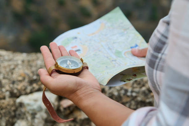 istock Traveler holding a compass and map, exploring the outdoors 2162906001