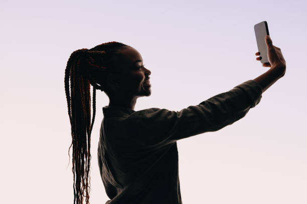 istock Confident young woman taking selfie with smartphone 2162906769