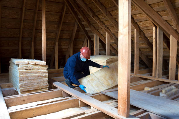 istock Roof insulation. A worker puts glass wool insulation in the attic. 2162908474