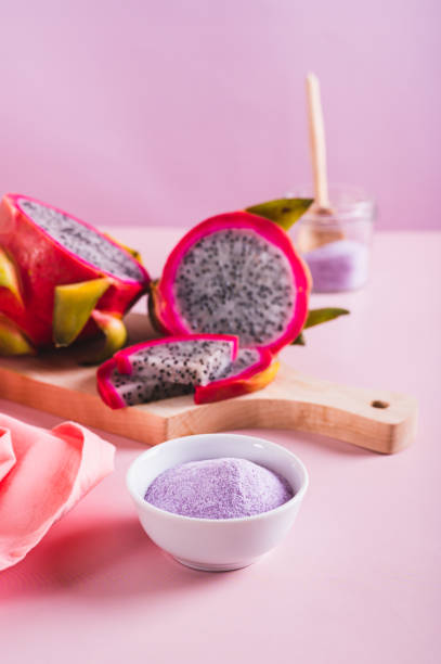 istock Pink matcha powder in a bowl and fresh dragon fruit on the table vertical view 2162908696
