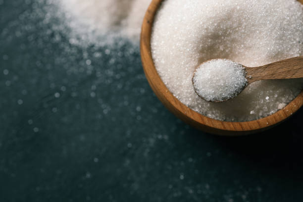 istock Wooden spoon with sugar on a plate 2162910049