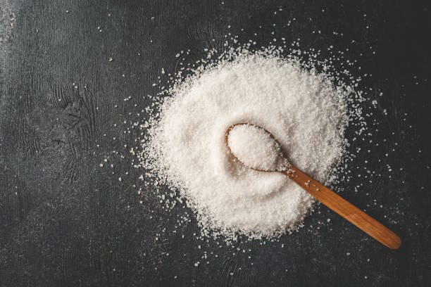 istock Wooden spoon with salt, splash, top view 2162910061