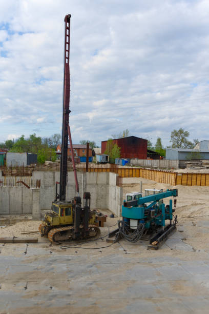 istock The image depicts a construction site with a pile driver and auxiliary equipment under a cloudy sky 2162910524