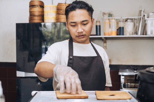 istock A Southeast Asian Chef Toasting Loafs 2162912852