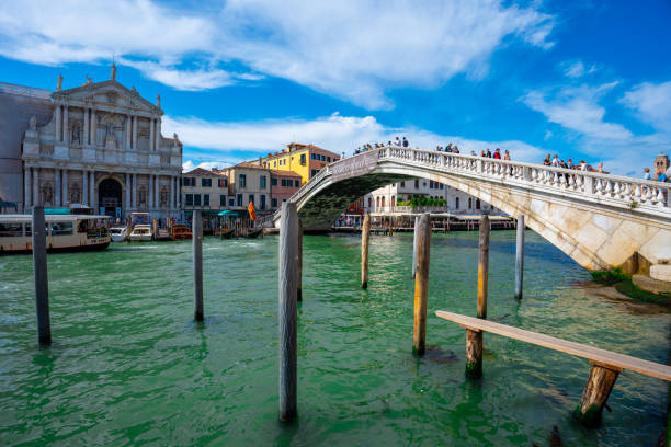Venice, Italy - June 03, 2024: Ponte degli Scalzi bridge. Palines on the foreground.