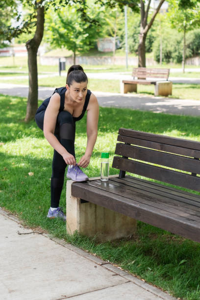 Young woman doing physical exercises outdoors.