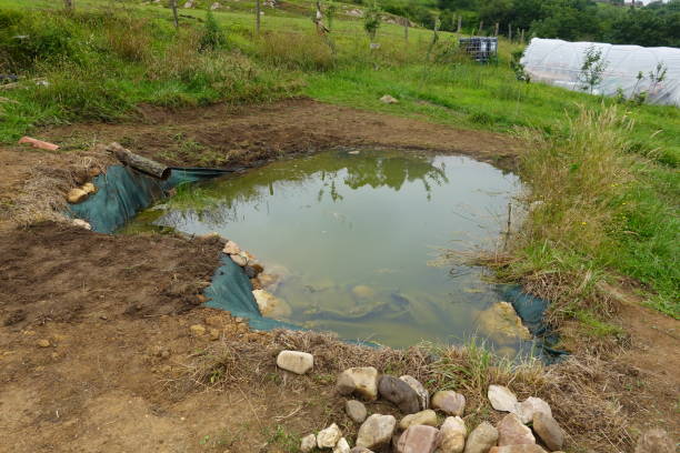 istock artificial lake with bordered areas for planting. lake for water and storage. 2162923782