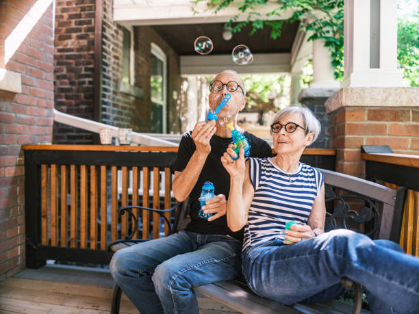 istock Senior couple making soap bubbles on the porch 2162924888
