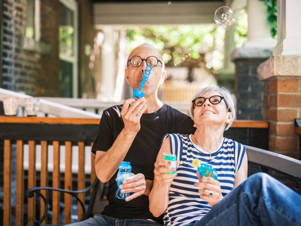 istock Senior couple making soap bubbles on the porch 2162924963