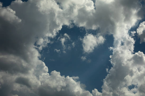 White clouds in summer. Clouds in blue sky. Weather details. Summer air.
