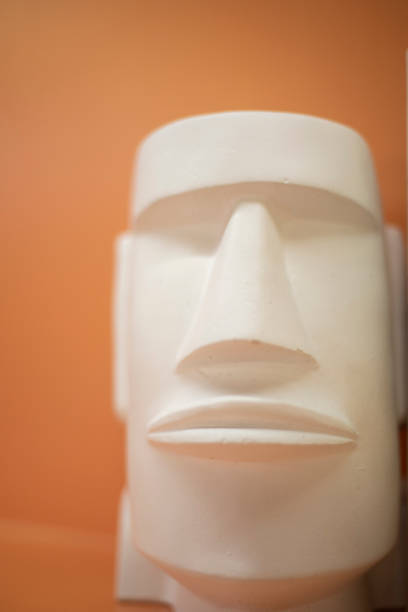 Plaster figurine. The face of a sculpture from Easter Island. White object in the interior. Souvenir from Easter Island.