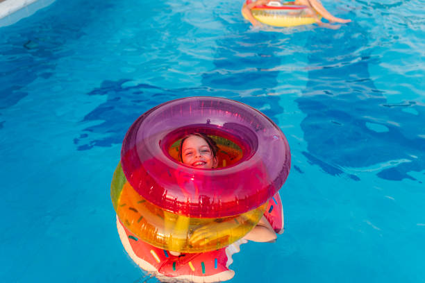 istock Children having so much fun playing with inflatable rings in the pool 2162932989