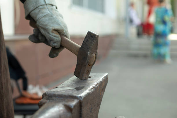Blacksmith hits anvil. Hammer and anvil. Metal Processing Details. Rameslennik works.