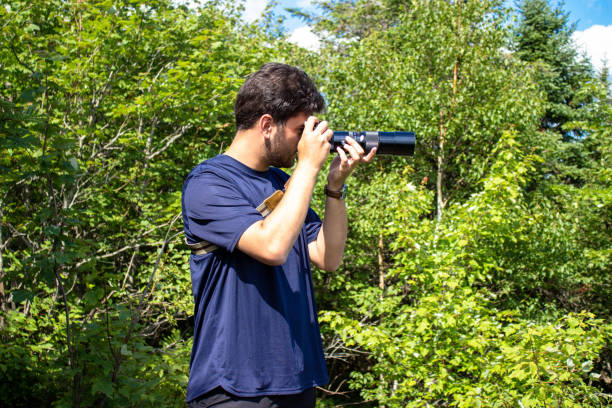 istock Young man taking photos in nature 2162938923