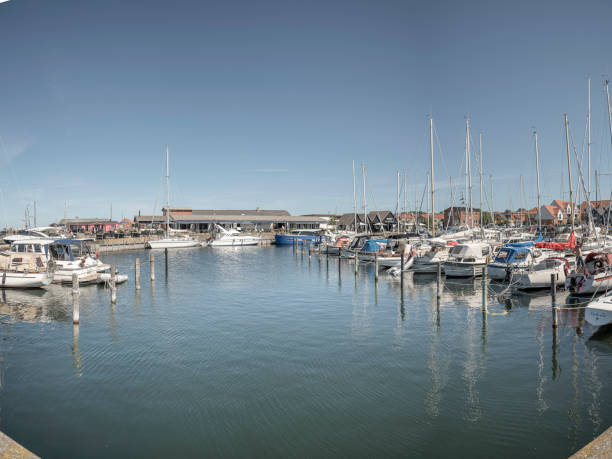 Panoramic view in Hundested marina vith moored sailboats and the reastaurant Knud in the background, Denmark, July 21, 2024