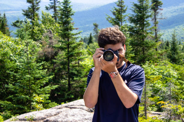 Young man taking photos in nature