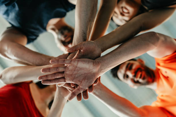 istock A group of people putting their hands together 2162940837
