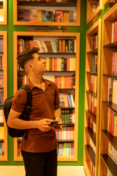 istock A university student choosing a book in a bookstore. 2162944788