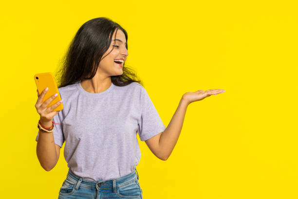 istock Woman using smartphone showing pointing empty place, advertising application area, positive feedback 2162947689