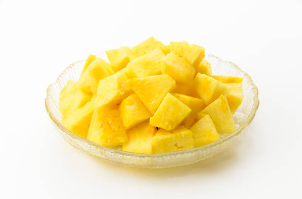istock Pineapple chunks on a transparent glass dish on white background 2162949322
