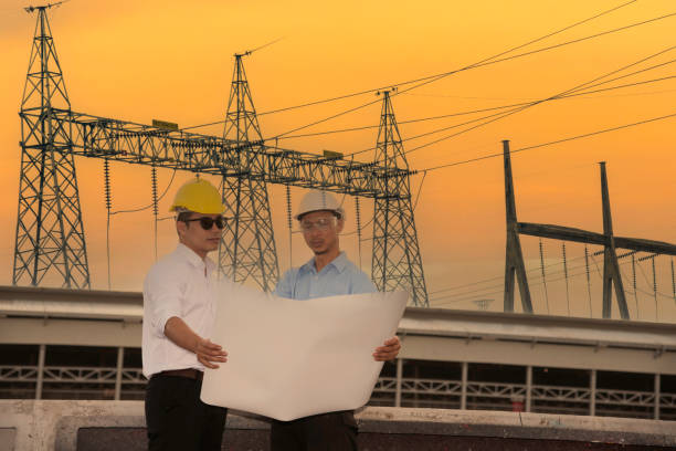 istock Two men engineer look at blueprint architecture building contractor design in modern city development. Males engineer holding project planing partner teamwork. Man meeting together construction site 2162953918