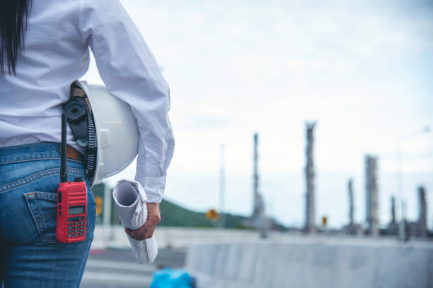 istock Engineer woman hands holding hardhat white work helmet hard hat for Construction Engineering. Refinery woman engineer oil industry hands hold worker helmet hard hat. Refinery industry engineering 2162954331