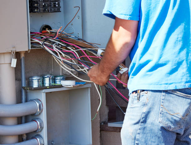 istock Electrician installing a transfer panel for a whole house generator 2162954451