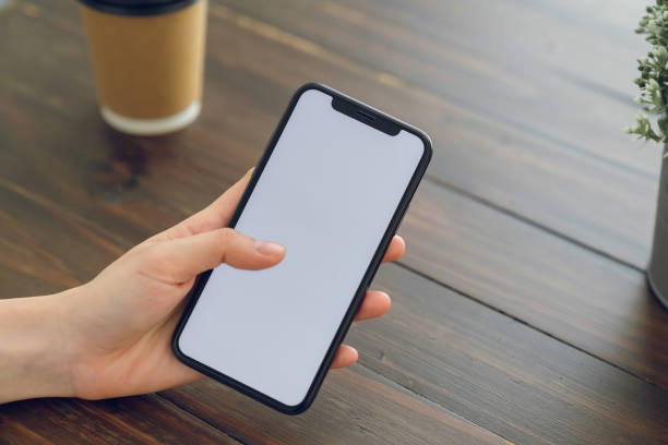 istock Hand holding smartphone mockup of blank screen for graphic display montage. 2162955505