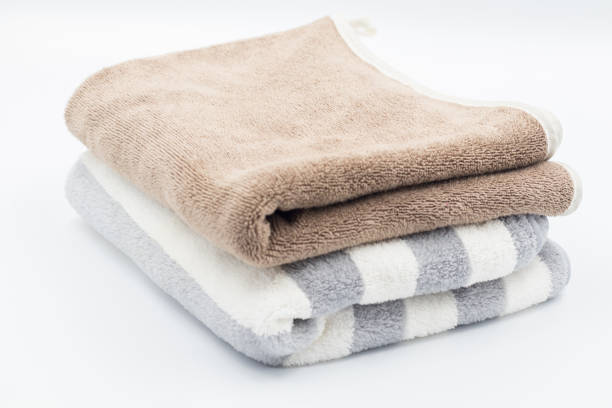 istock Clean bathroom towels laid out in rows, Rolled soft terry towel , Folded soft terry towel. 2162956349