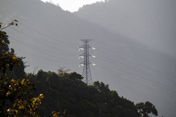 Extra high voltage Electric Pole Tower on top of green hills