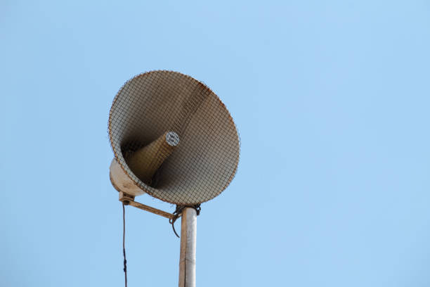 Outdoor loudspeakers with bright blue sky background