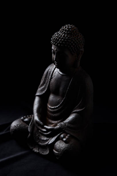 istock Meditating Buddha Statue on dark background. Soft focus. Close up. Copy space. 2162957472