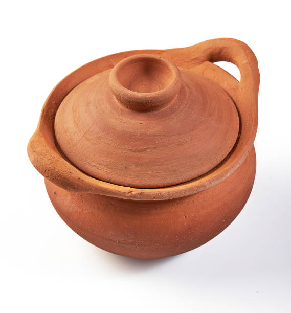 Clay pot (earthenware pot) with lid isolated on white background. Pottery is the process of making containers out of clay and burning. Vintage, Retro and Antique Kitchenware.