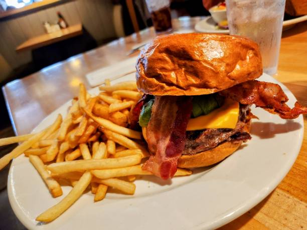istock Close-up of a delicious all beef cheeseburger with melted cheese and assorted toppings. 2162957699