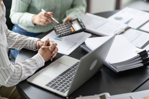 auditor or internal revenue service staff, business women checking annual financial statements of company. audit concept - accountancy fotos stockfoto's en -beelden